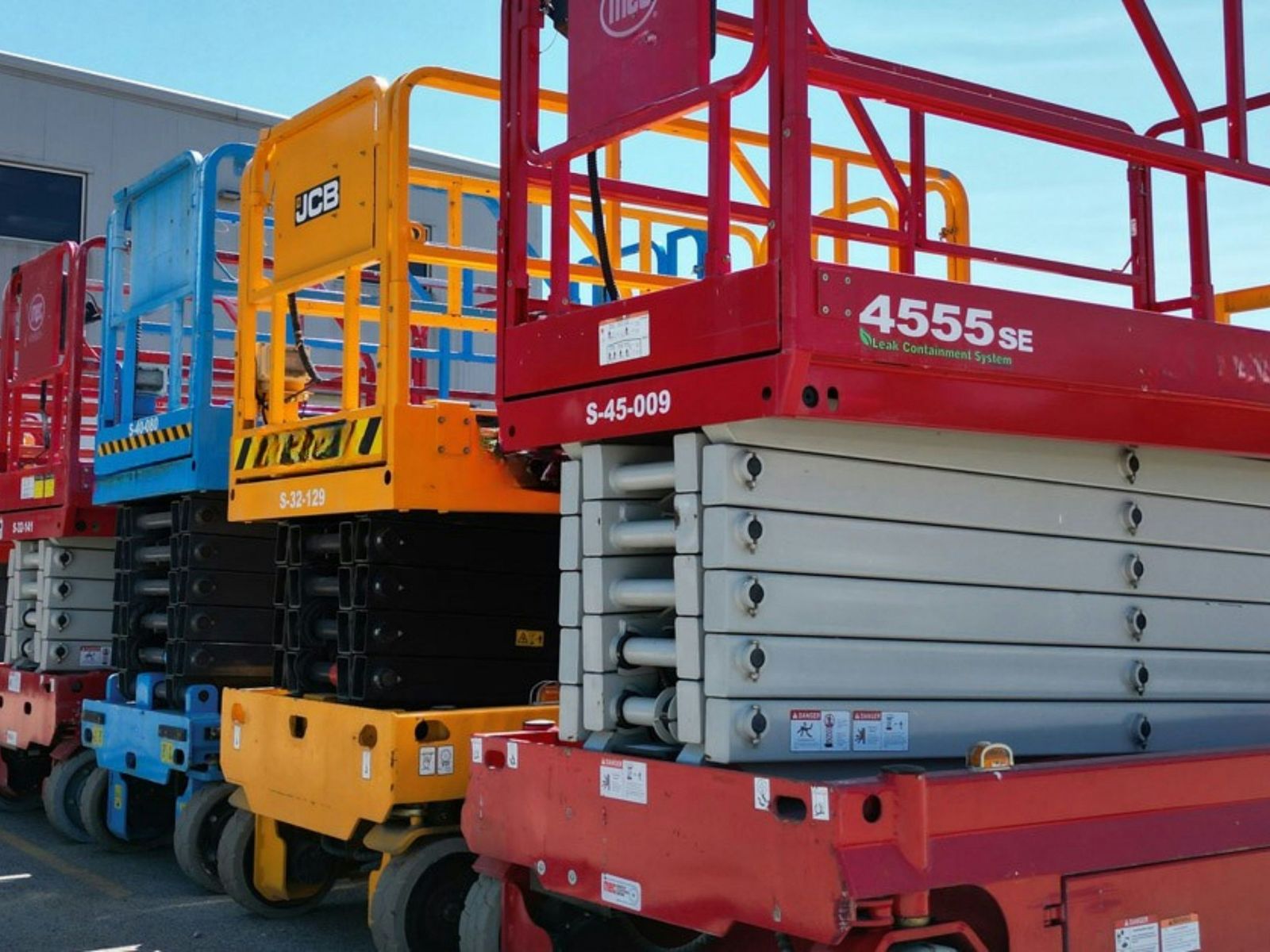 Row of scissor lifts in a fleet yard
