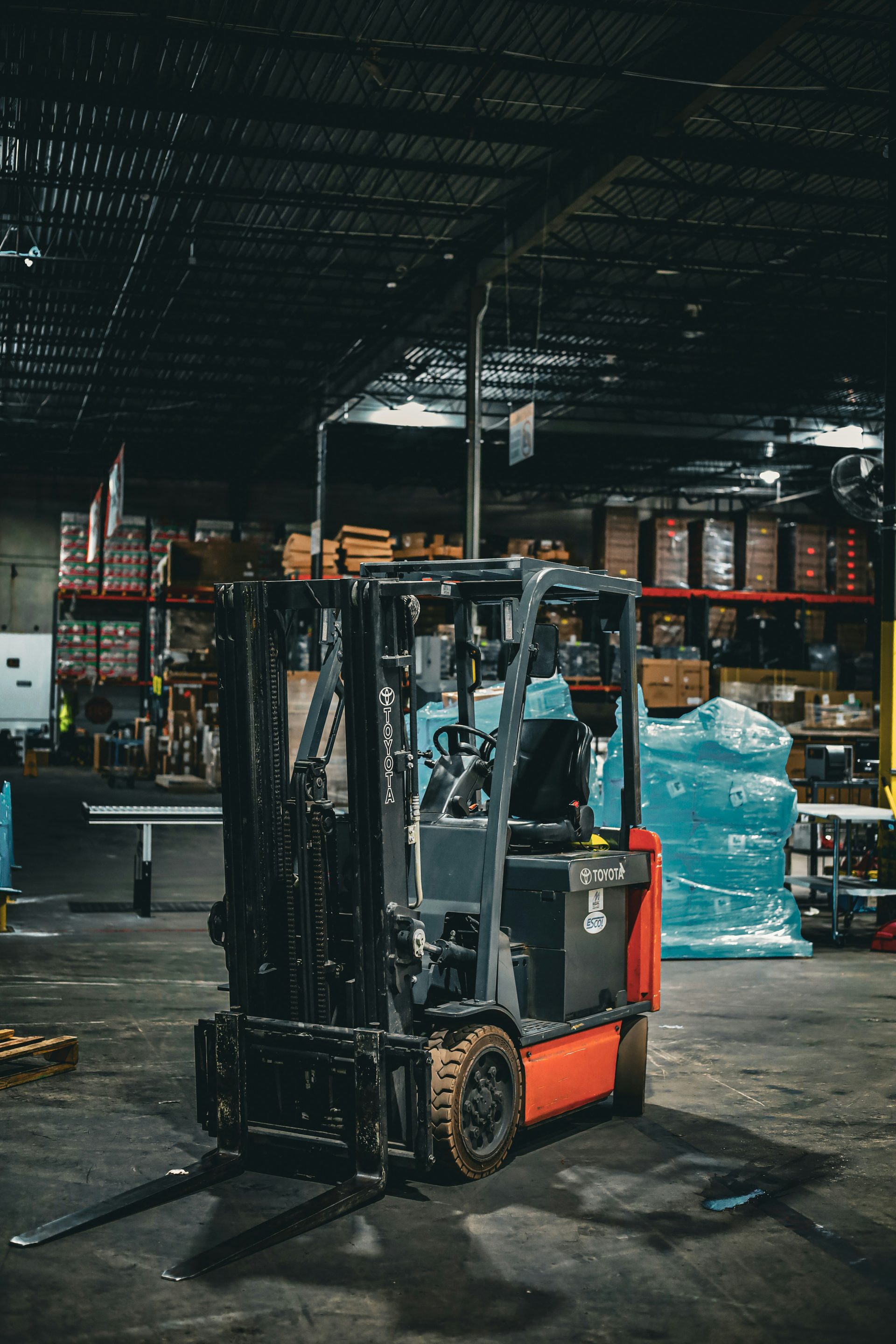 Forklift moving pallets in a distributor warehouse